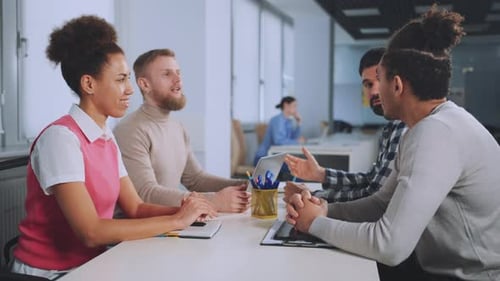 Four People at an Office Table Having Meeting