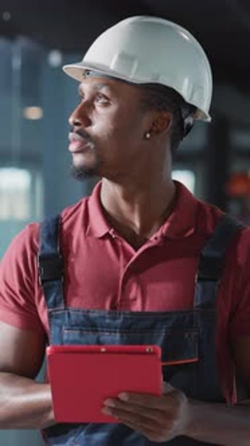 A Construction Worker is Utilizing a Tablet for Effective Project Management Purposes