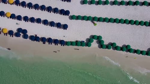 Destin Florida beach service chairs on the beach with Gulf of mexico turquoise green water, Key west