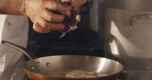 Chef Grating Truffles into Frying Pan