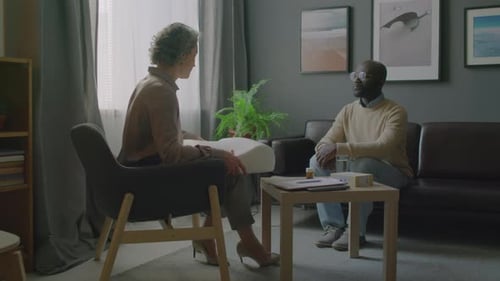 Therapist Giving Patient a Pillow in Counseling Session