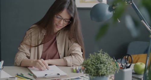 Creative Designer Drawing Picture Working in Modern Office Sitting at Desk Alone