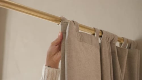 Closeup of girl closing changing room curtain