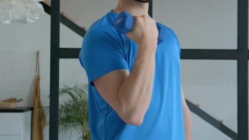 Man Lifting Dumbbell in Home Workout Setting