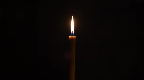 Candle in the Dark Candle Flame in the Temple on a Black Background