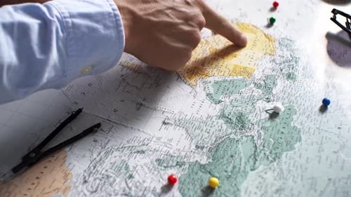 Adults Planning Travel with Map and Push Pins