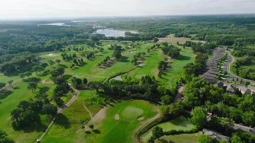 aerial drone shot of a golf course with multiple golf holes in view
