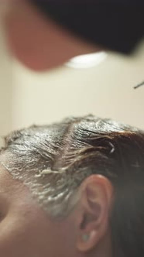 Woman Getting Hair Dyed with a Brush