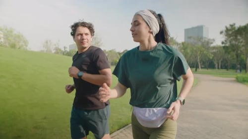 Young Couple Running in Park