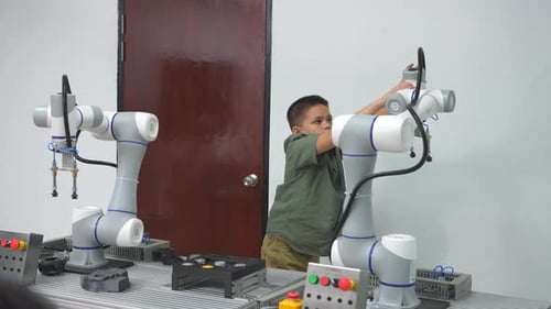 schoolkids learning using gadgets and building robots on software robotics engineering class.