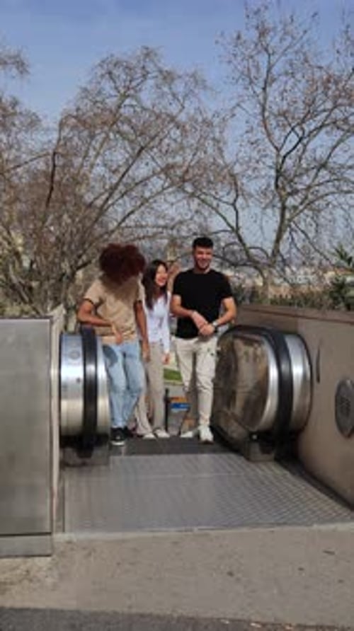 Vertical View of Group of Three Multiracial Young Friends Having Fun and Smiling Looking at Camera