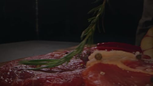 Uncooked Steak with Rosemary and Garlic Close Up