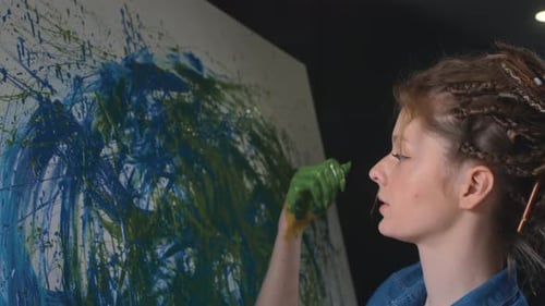 Young Woman Painting Abstract Art with Her Hands