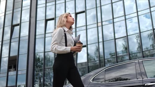 Stylish Blonde Business Woman Walking at Downtown District Modern Urban Office Building Street