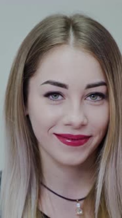 Blonde Woman Smiling and Wearing Red Lipstick