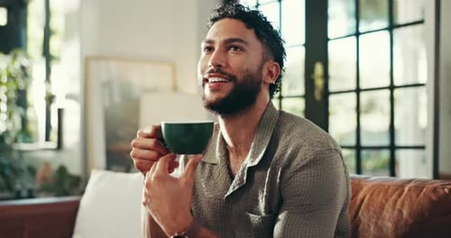 Man Enjoys Coffee on Couch at Home