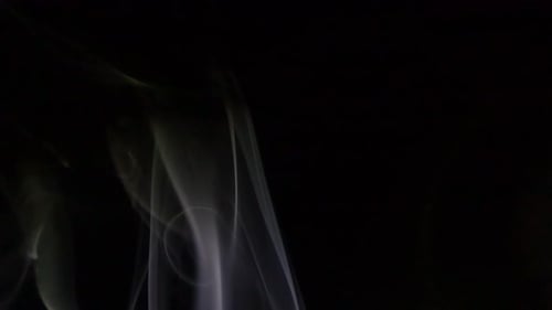 Wispy White Smoke Rising on Black Background