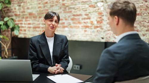 Businesswoman And Businessman Shaking Hands After Successful Meeting In Office
