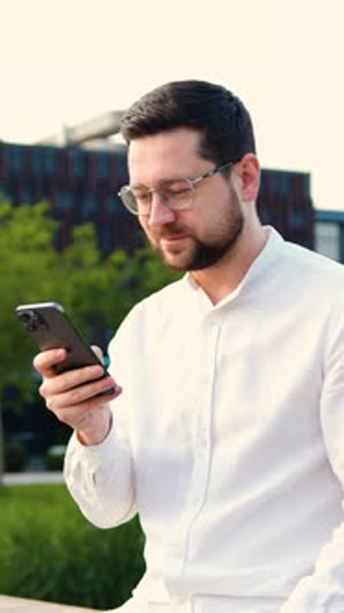 Serious Businessman Using on Mobile Phone Standing on Street Near Office Building Handsome Male