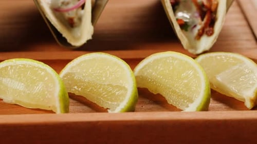 Tacos with Lemons on a Wooden Board