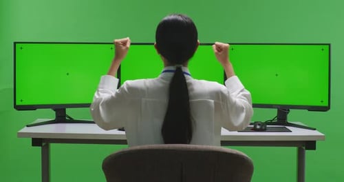 Happy Woman Celebrating And Dancing While Working With Mock Up Multiple Monitor On Green Screen