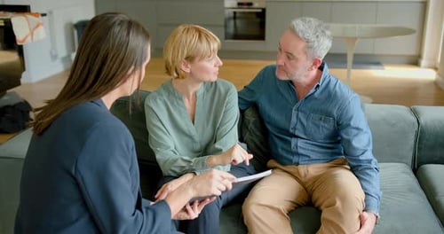 Financial Advisor Meeting Couple Inside Modern Home