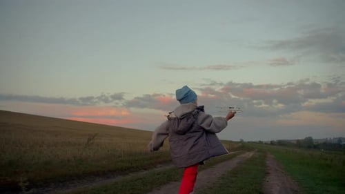 Little Boy Running with an Airplane