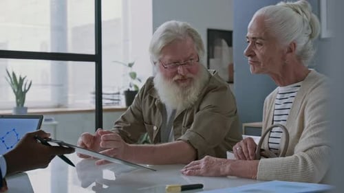 Senior Couple Having Consultation with Financial Advisor in Office