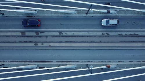 Looking straight down onto cable stayed bridge with vehicle traffic