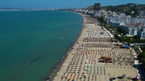 Large sandy beach on the Durres coast, Albania, with hotels and resorts for tourists to relax and su