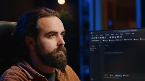 Man Thinking in Front of a Computer at Night