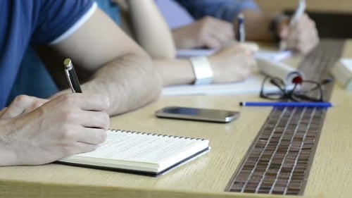 Closeup of Man Taking Down Note in Diary. Close Up Of