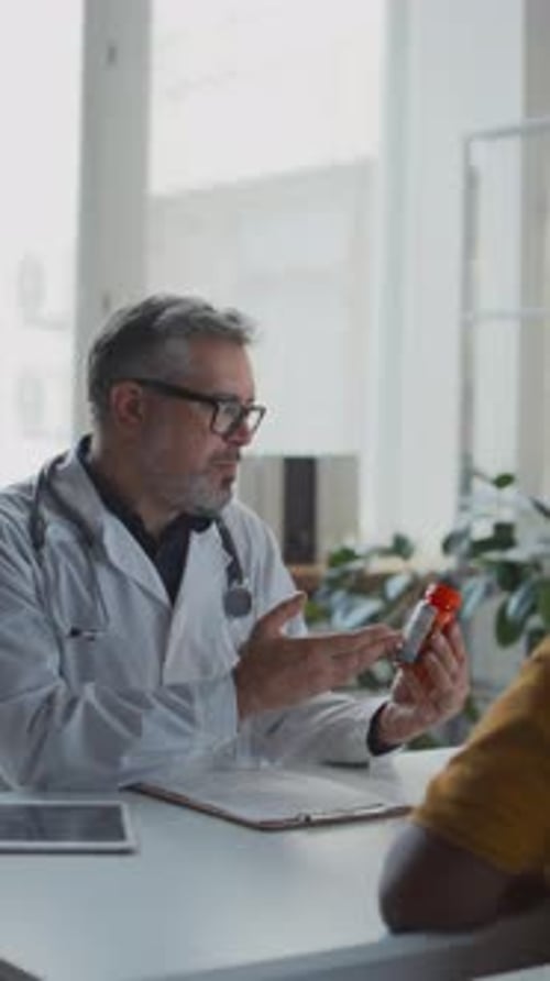 Doctor Explaining Prescription Medicine in Clinic Office