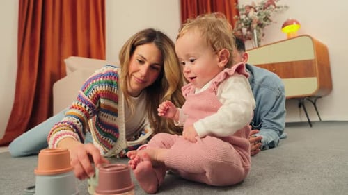 Loving Family Playing with Baby on Floor