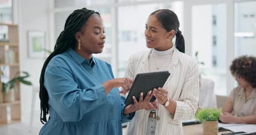 Young Adults Discussing Tablet in Modern Office