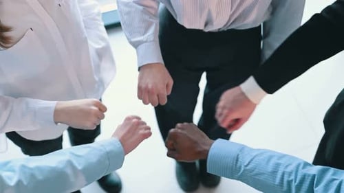 Fists to fists gesture. Top view of hands of business people that are celebrating success.