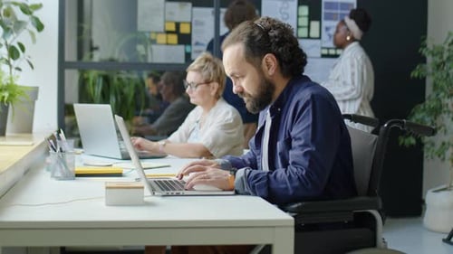 Man in Wheelchair Working in Office
