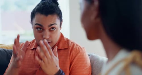 Adult Couple Talking Indoors On Couch