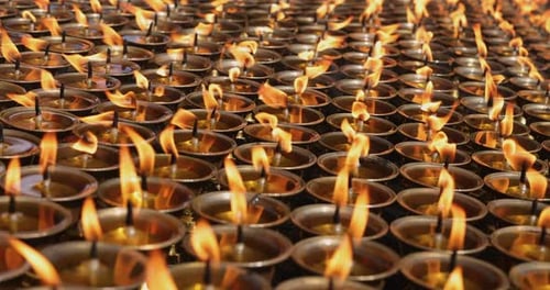 Rows of candles flickering slowly in a monastery in Nepal.