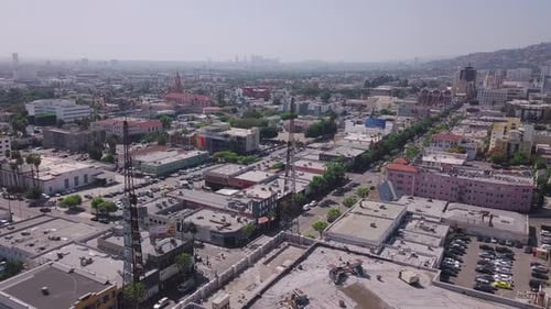LA: Drone shot parallax over Hollywood Boulevard looking out towards West LA with radio spires in th