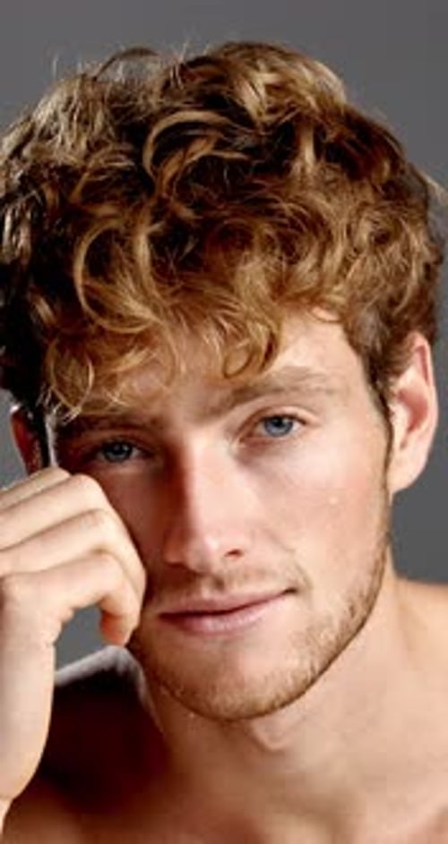 Face, skincare and smile of man in studio for grooming, hygiene or masculine beauty or wellness