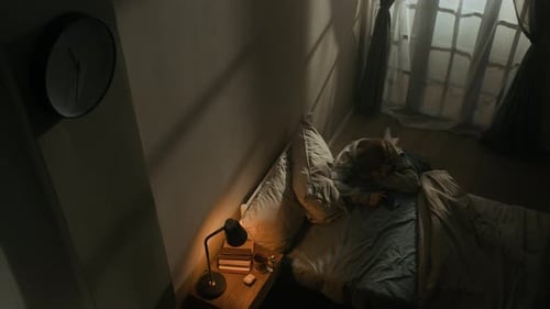 Young Woman Suffering from Inability to Sleep in Bedroom at Night