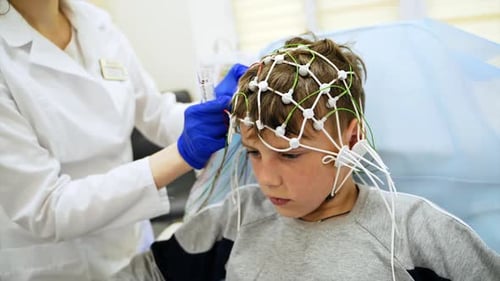 Caucasian boy sitting peacefully waiting for the brain test procedure.
