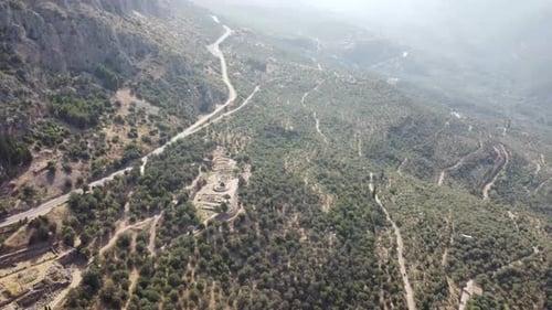 Distant Aerial Establishing shot of Delphi Oracle in Greece. Tourist attraction spot.