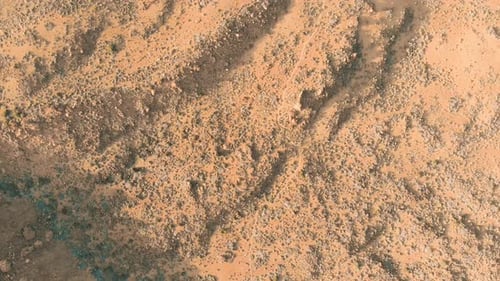 Desert volcanic landscape in red. Stones and a mountain with a volcano.