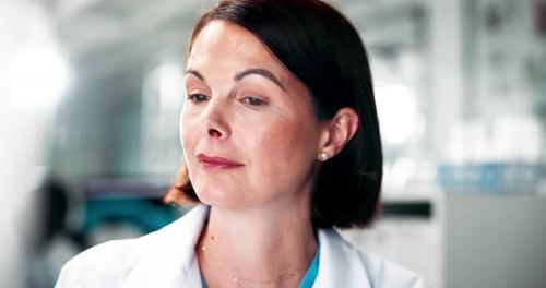 Confident Woman in Lab Coat Looking Away