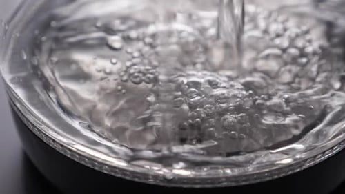 Filling Electric Kettle With Water and Bubbles