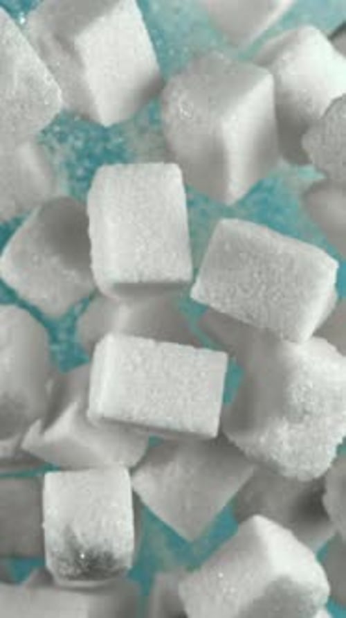 Cubes of Sugar Fly Up and Fall Down on a Blue Background Filmed on a Highspeed Camera at 1000 Fps