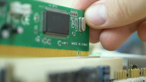 PC Repair Master Inserts PCI Board Into Motherboard Area