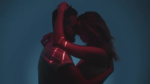 A Young Couple is Kissing in the Studio